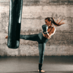 woman kicking a punch bag