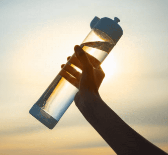 Water-Hydration a hand holding up a water bottle
